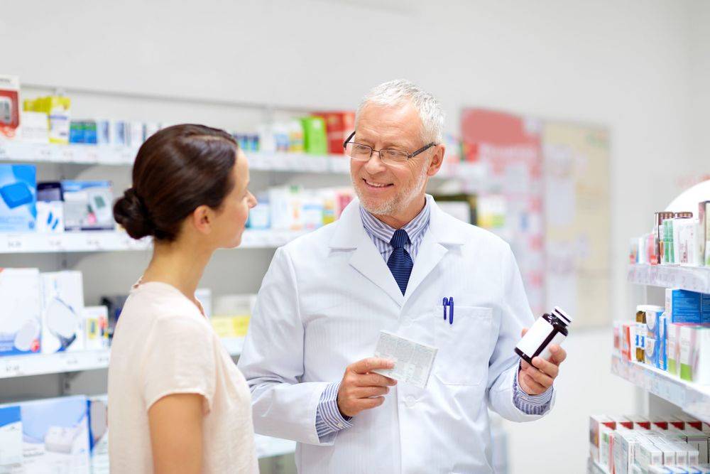 Pharmacist with patient